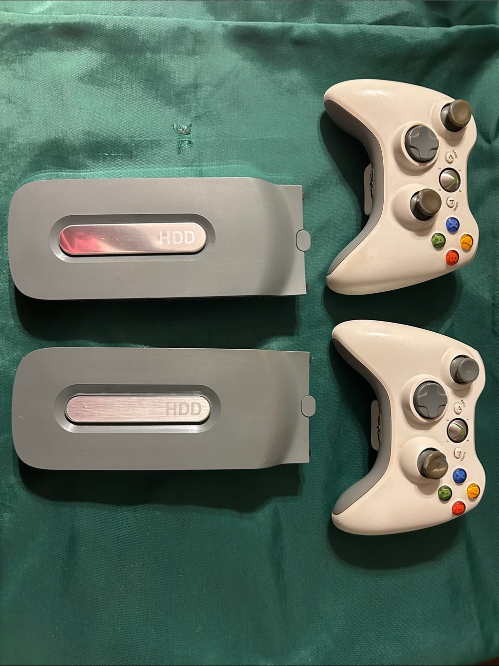 2 Xbox 360 White Wireless Controllers and 2 hard drives sold altogether